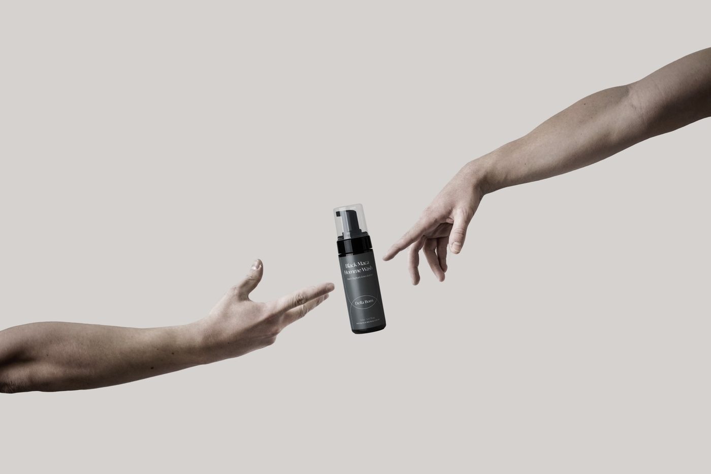 Two hands reaching toward the bottle
