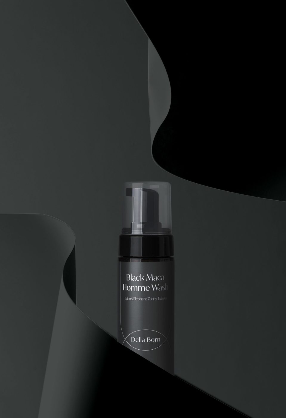 Main visual: Homme bottle in a dark curved scene