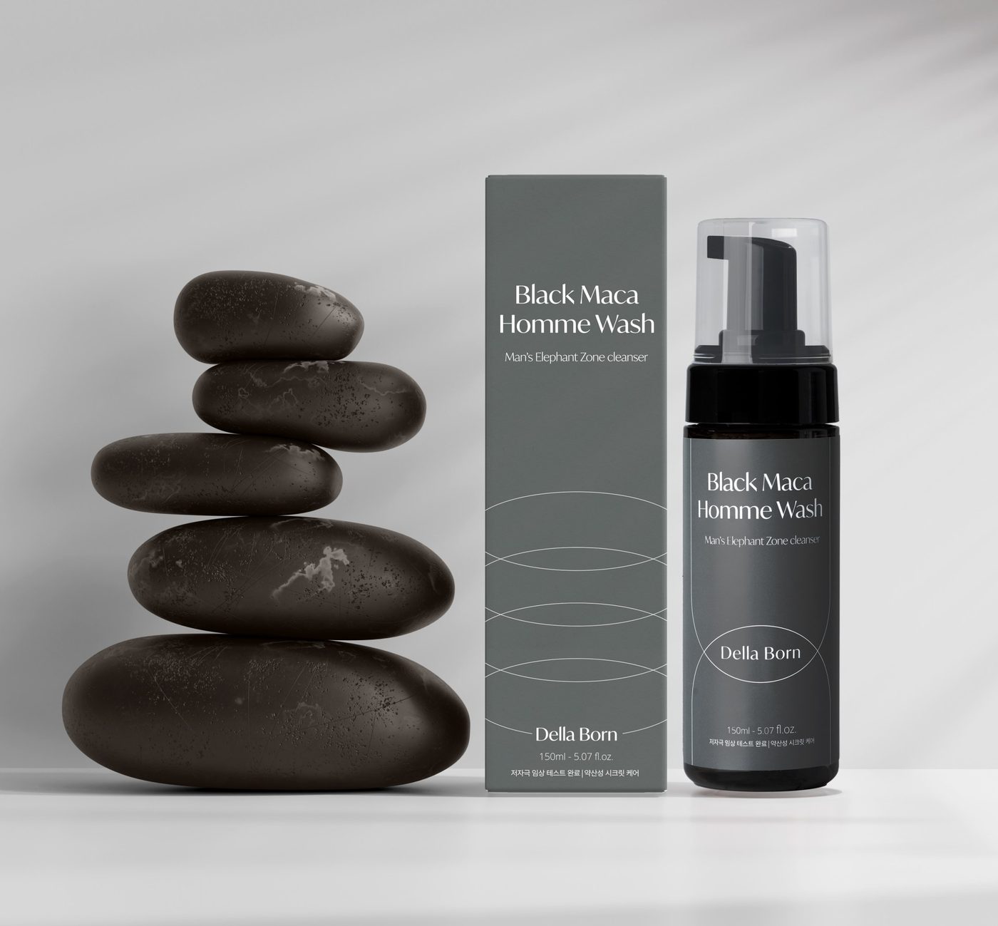 Homme bottle beside stacked stones